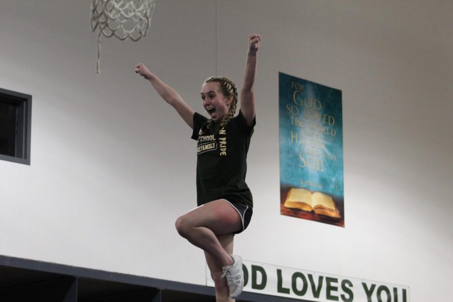 Junior Izzy Ward practicing a stunt for the competition routine.
