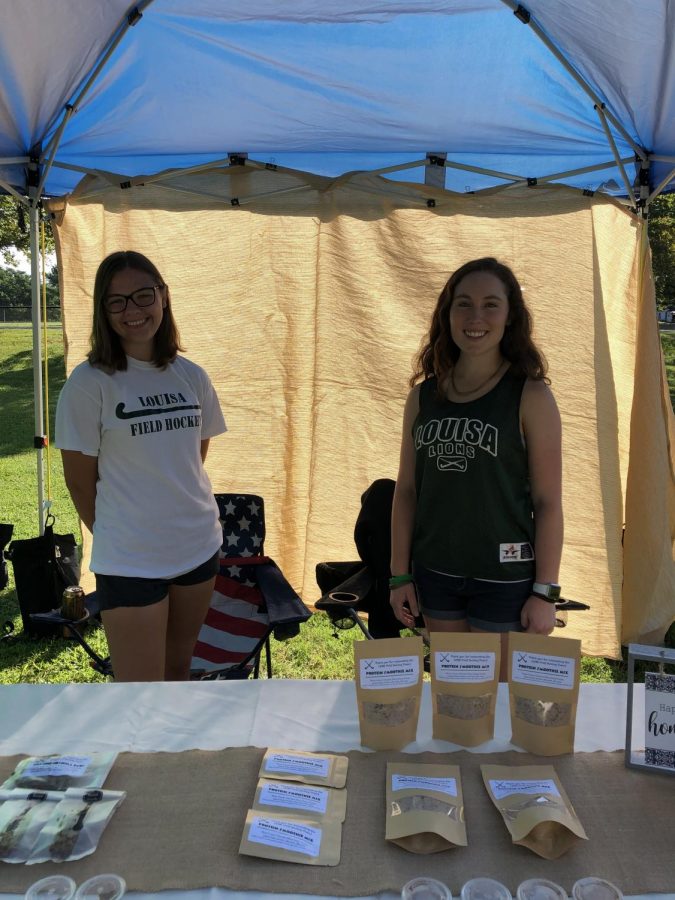 Seniors, Ali Downey and Lydia Gillespie working at the Mineral Farmers Market to raise money for Field Hockey. 