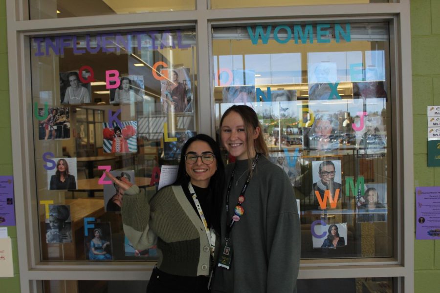 College Advisor Ludymila Avagyan and Counseling Intern Kate Serrao stand in front of the Womens History Activity the library put on. 