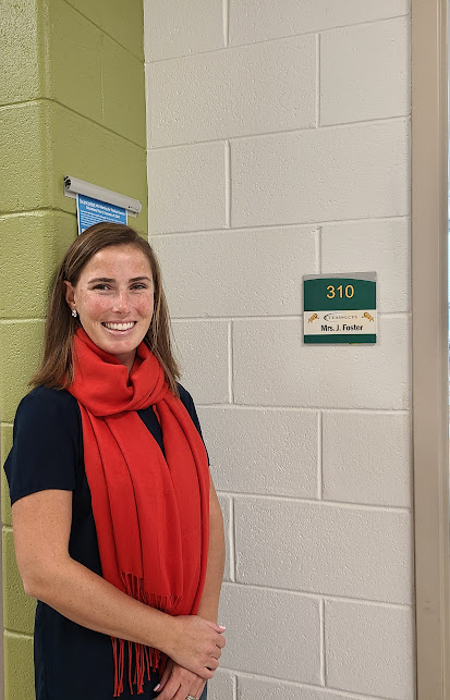 Jennifer Foster poses in front of her room, 310.  