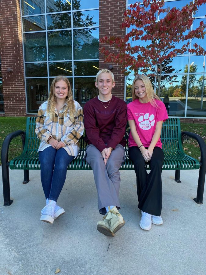 Treasurer Kaylee Nuckols, Vice President Kage Harlow, and Secretary Dallas Sprouse pose for a photo outside of the high school. President Makiah Holcomb was absent the day of the photo.