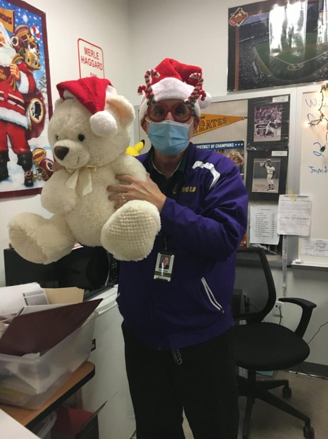 Mr. Stickley poses in his Christmas accessories holding a donated stuffed animal.
