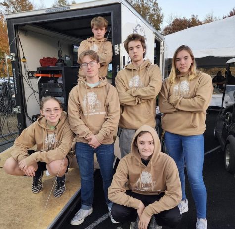 Louisas media interns preparing for a Friday nigh football game.