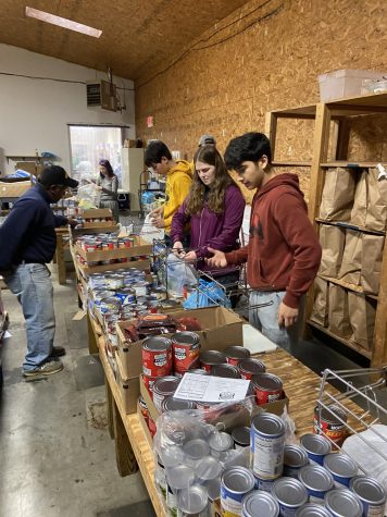 Students in the Louisa Resource Council packaging food during their Async. Day. 