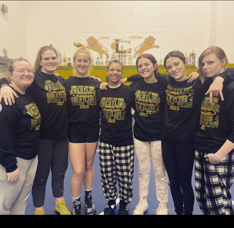 Louisa’s Varsity Girls Wrestling team posing for the team picture, featuring Kailyn Myers, 
Marion Zimmerman,
Amya Barbour,
Catherine Meyers,
Taylor Waddy, Kaylee Hustead and Langley Amiss.