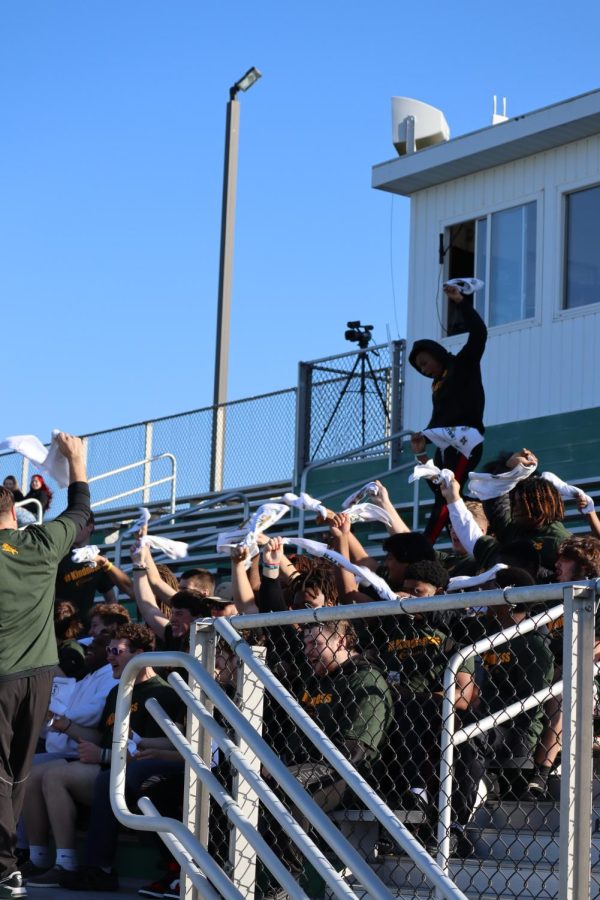 The high school varsity football team getting hype before the rally. 