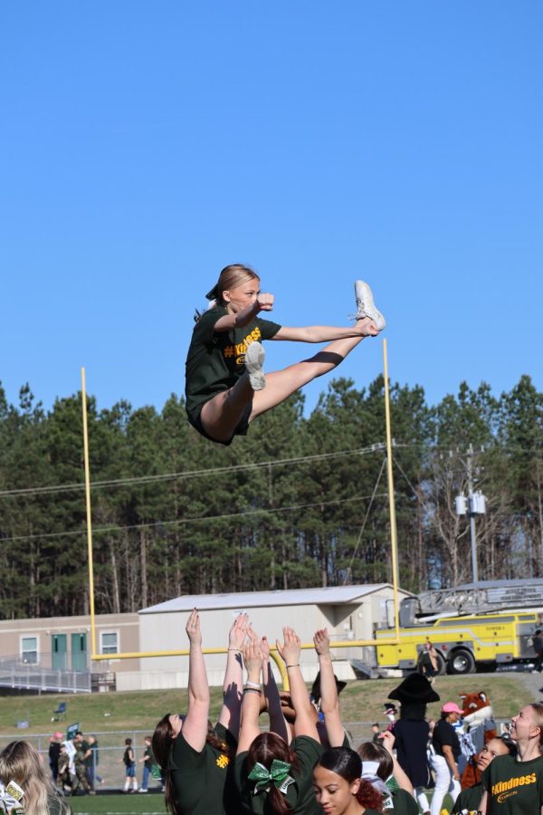 Cheerleader Dallas Sprouse pulled a toe-touch in a basket toss.