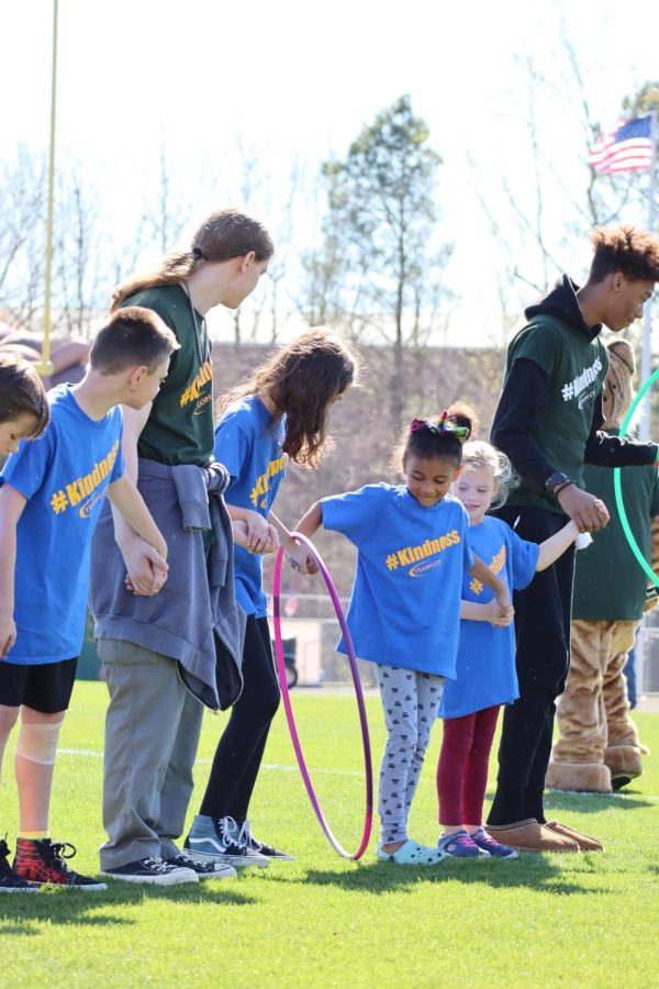 Jouett Elementary students and select high schoolers play a hool-a-hoop game. 