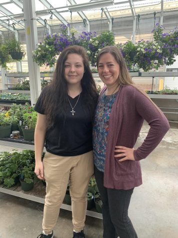 Kayden Belverio and Miranda Moyer outside in the greenhouse. Photo credits to Casey Little.