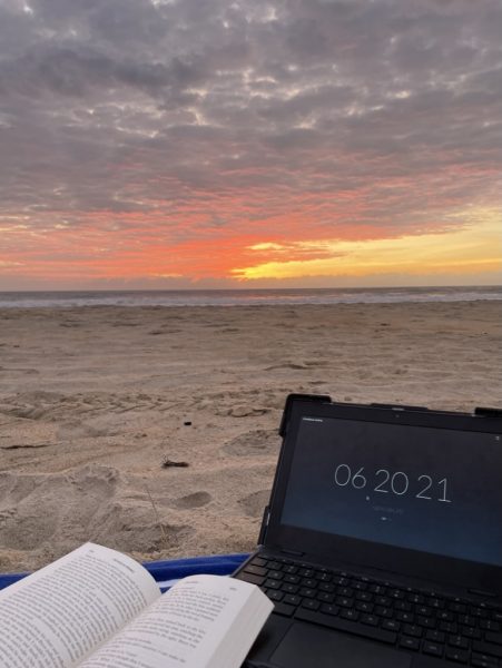 I woke up early to watch the sunrise on the beach while also doing school work.