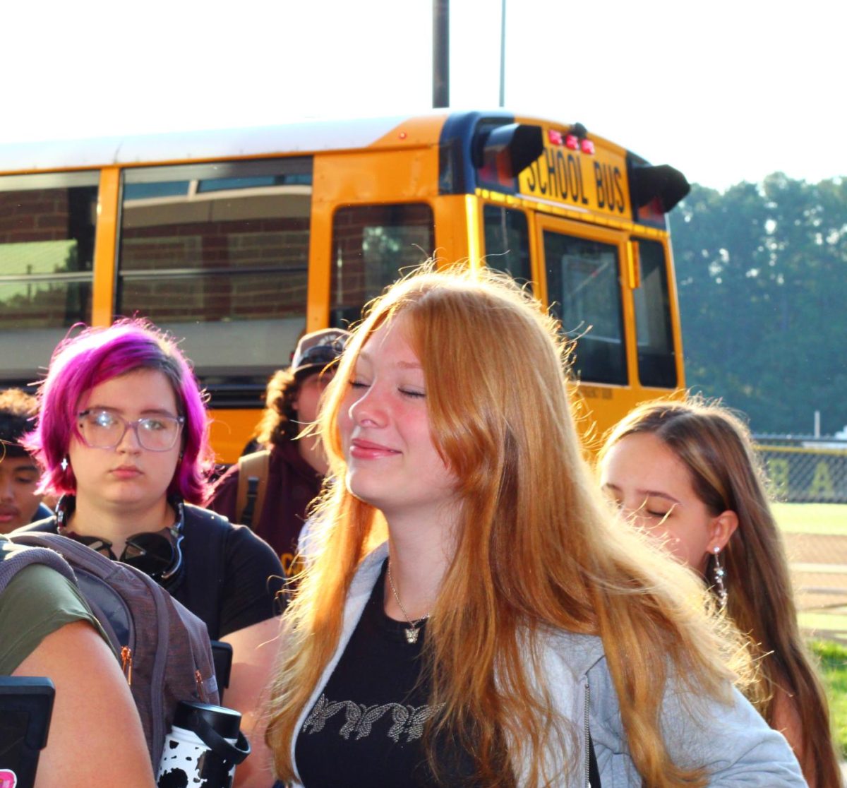 Students get off the busses and head into the building.  Some are more awake than others.