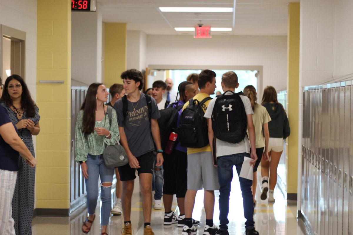 As students head to their first periods, they catch up on their summer vacations, compare schedules, or find something to smile about.