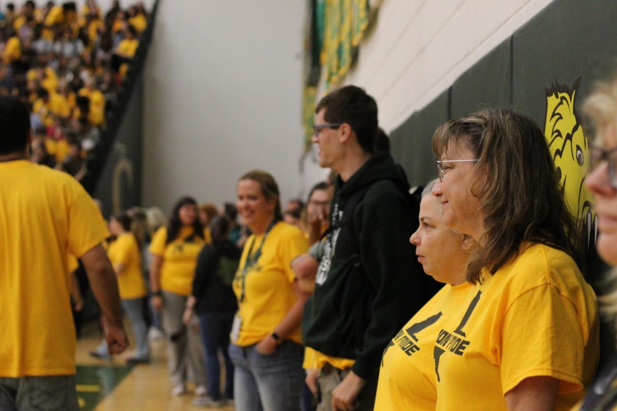 Teachers line up and watch the pep-rally as they start to begin the games.