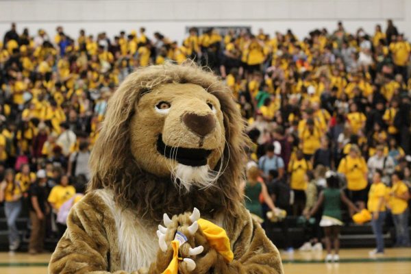 Lion mascot watching the students as they start to leave and get ready for the first home football game.