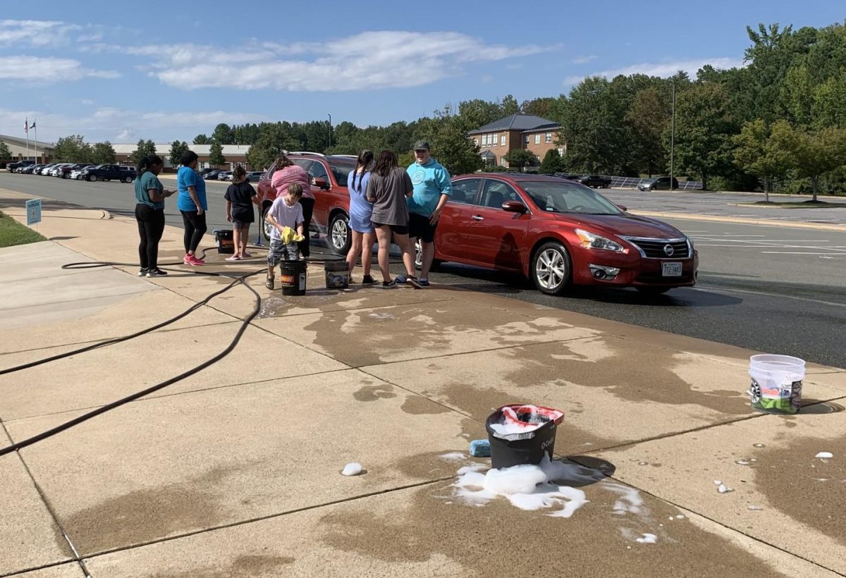 FCCLA students work together to clean one of the teachers cars. 
