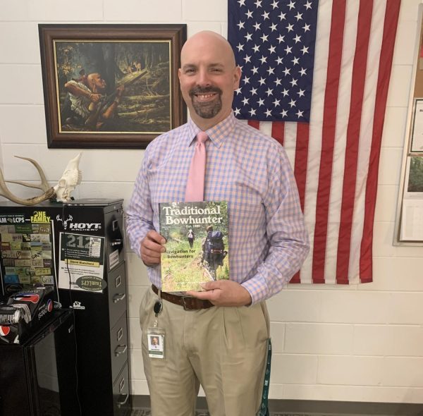 Assistant principal David Blanchard proudly showing off his bow hunting article in “Traditional Bowhunter” magazine.