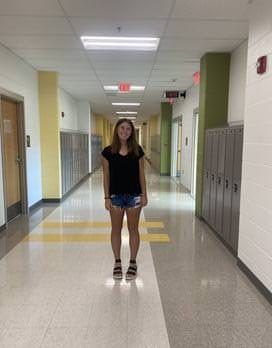A first team district winner, junior Gabriella McGehee stands proudly in the hall for a photo. 