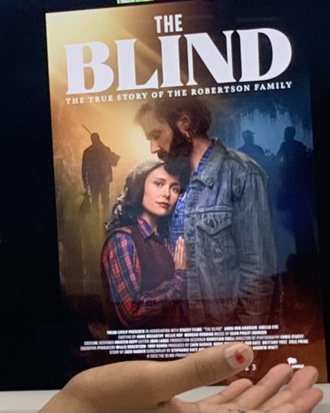 Junior Myles Mackie showing off poster of The blind.