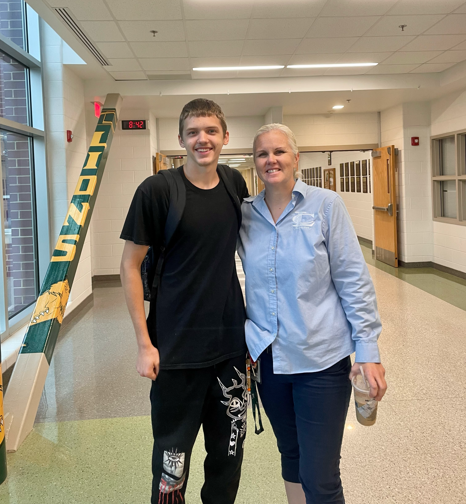 Zachary Hodges poses in the hallway with one of his favorite administrators, Dr. Thiemann.