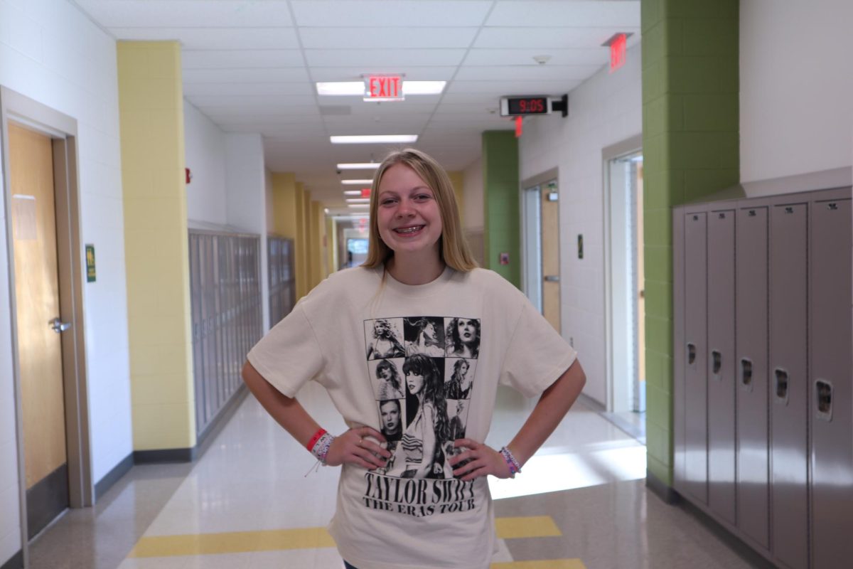 Sophomore Emma Ryan wears her Eras Tour concert merch with a smile on her face.