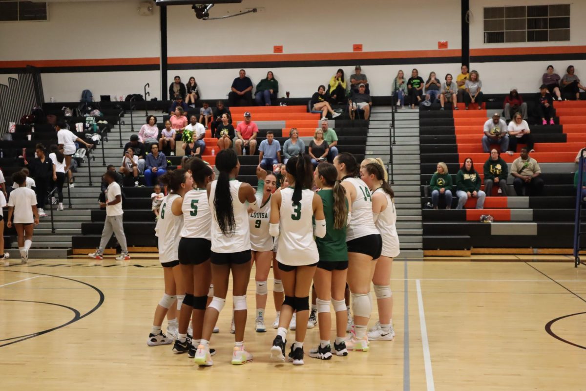 The varsity volleyball team chanting to hype each other up before the game against Charlottesville began.
