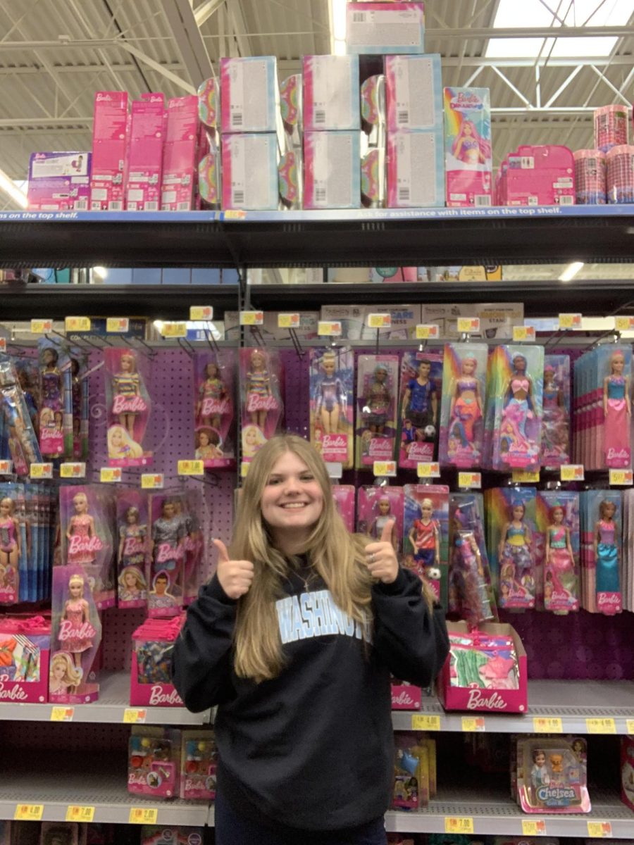 Senior Gracen Tate posing in the Barbie themed isle inside of Walmart.