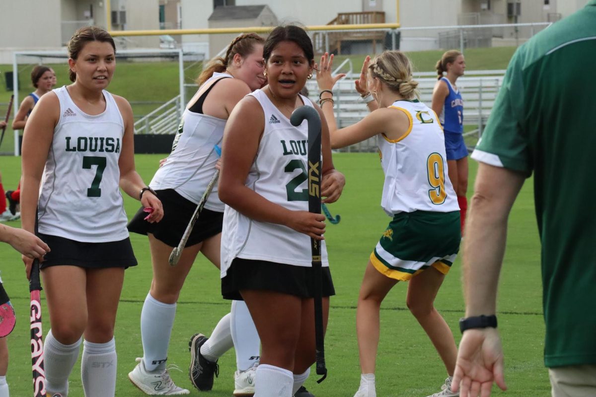 Varsity player, Karleigh Lundy celebrating with the Junior varsity players after their first goal.