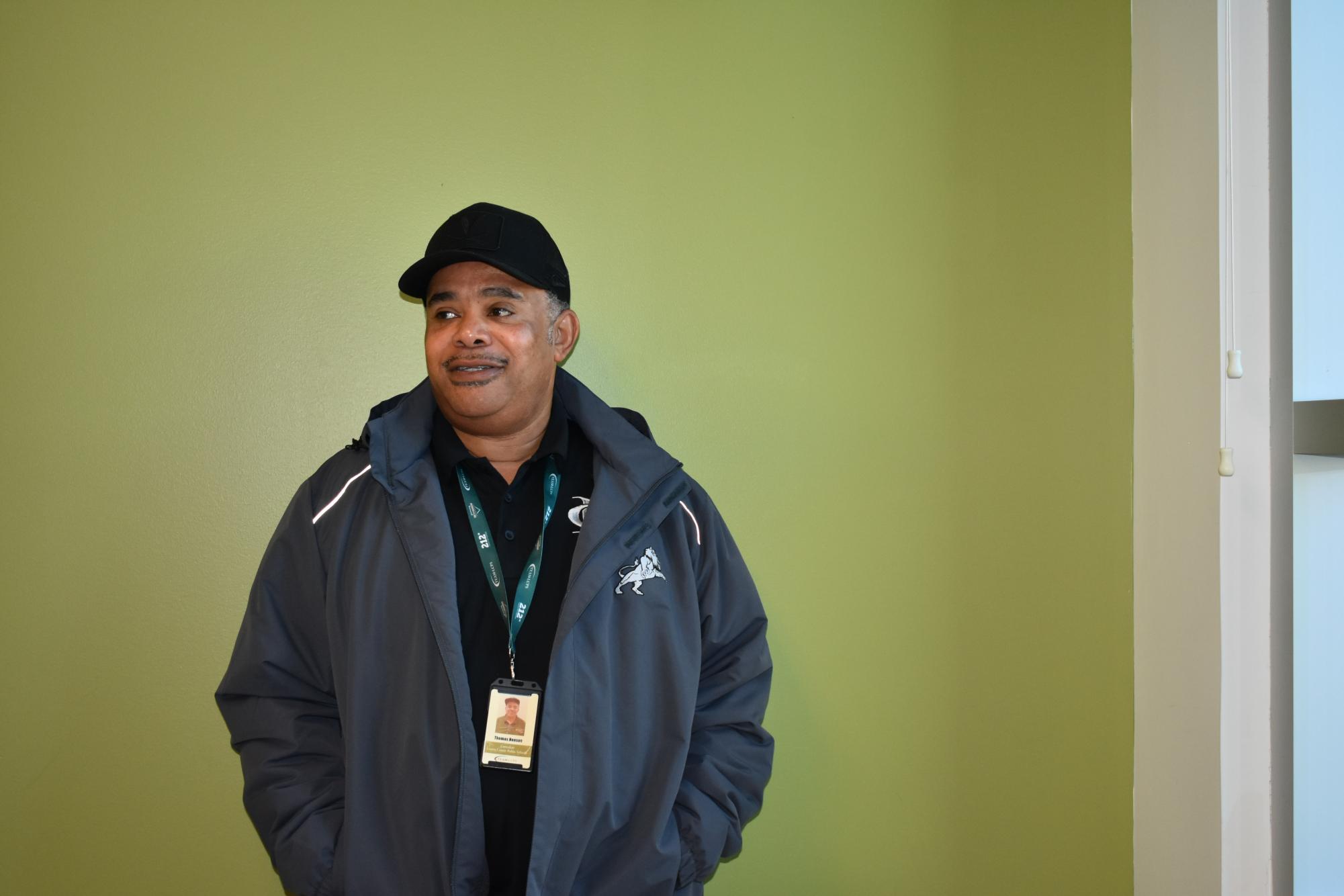 Thomas Hanson, a custodian stands in the hallway of the high school for a photo. 