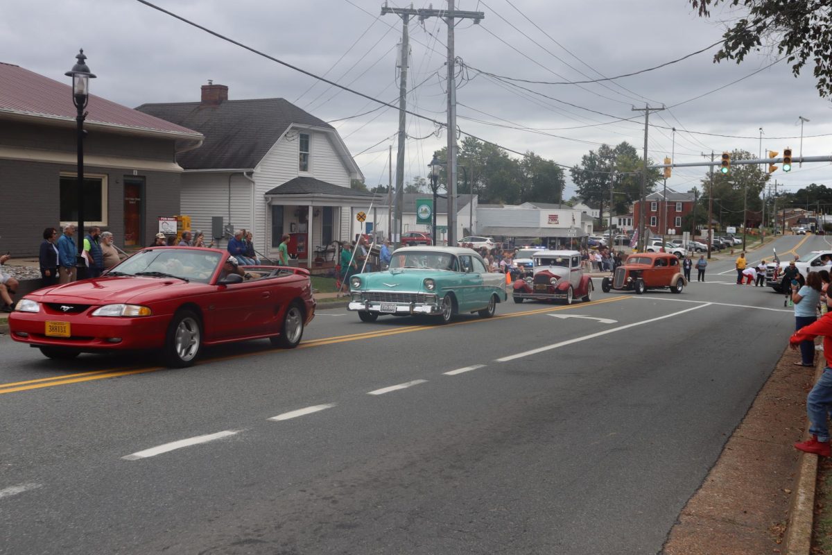 A group of vintage cars drive down center street to show off their Louisa County pride 
