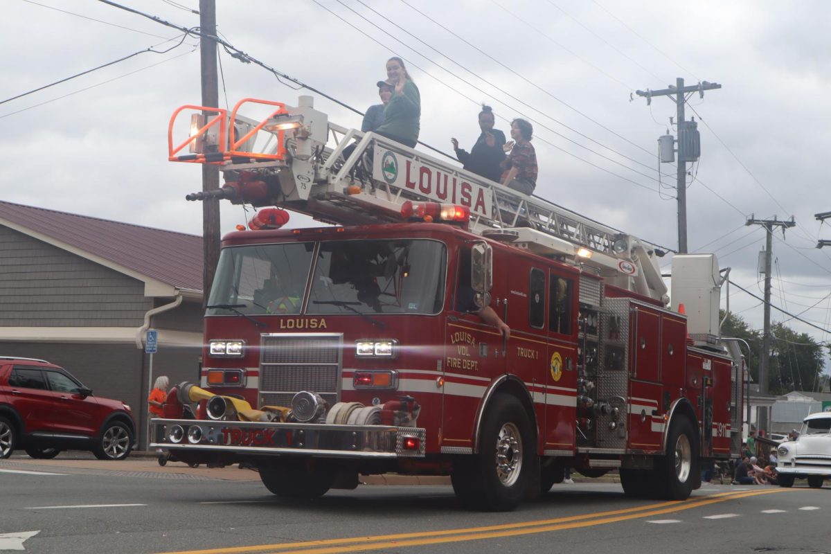 Representatives of the fire department wave to onlookers of the parade and show off their lights. 
