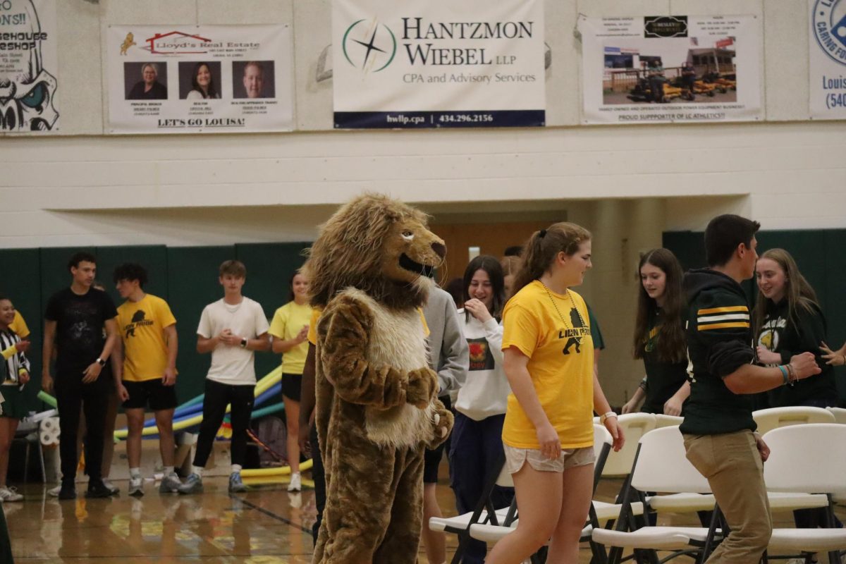 Louis A. Lion participating in the game of musical chairs at the pep rally with other players