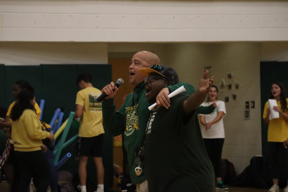Mr. Redd and Mr. Lee singing together to end off the pep rally on a good note