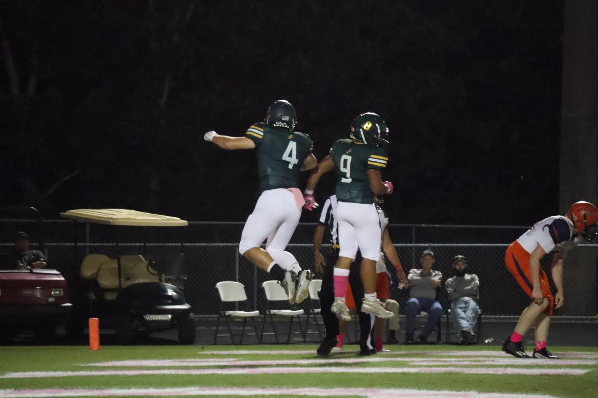 Adam Mills and Jayden Seaberry celebrating with each other in the air after a touchdown