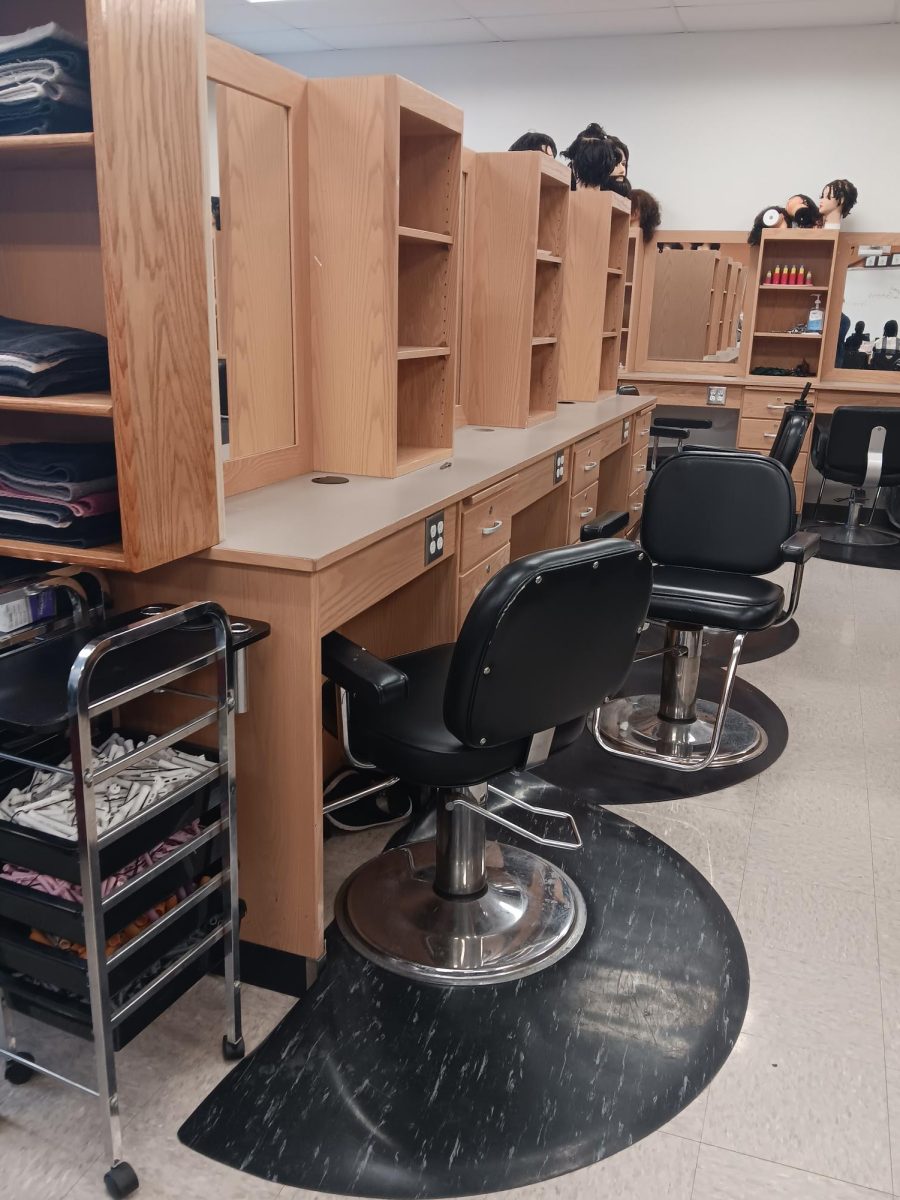 The schools cosmetology and barbering lab with lots of practice tools and stations 