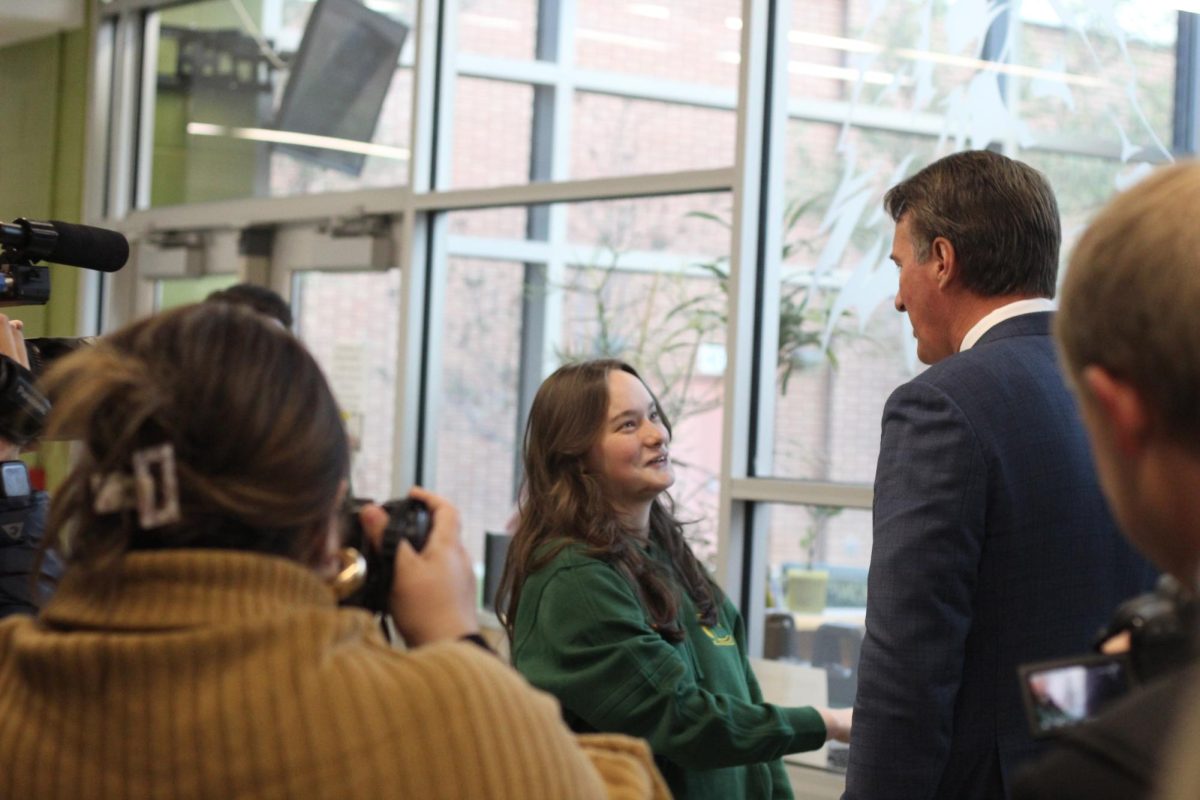 Senior Madelyn Wilson greeting and conversing with the Virginia Governor Glenn Youngkin when visiting the school