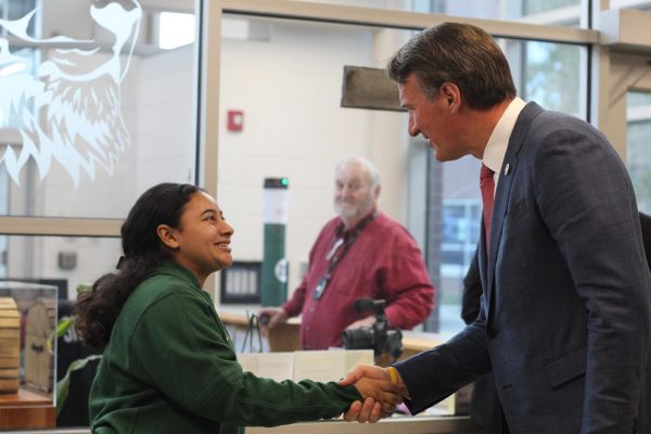 Senior Danielle Scott Greeting and welcoming the Virginia Governor Glenn Youngkin when arriving at the school.