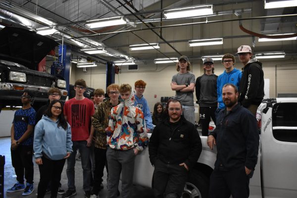 Mr. Robertson smiling for a picture with Mr. Galanti and his first period auto class.