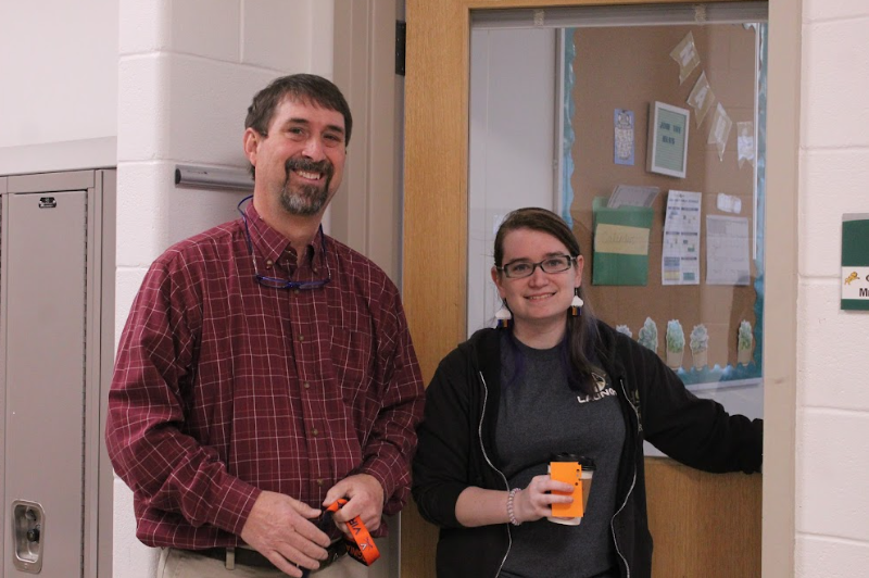 Mr. Schick and Mrs.LaBarr pose together outside of Mrs.LaBarrs room for a picture.