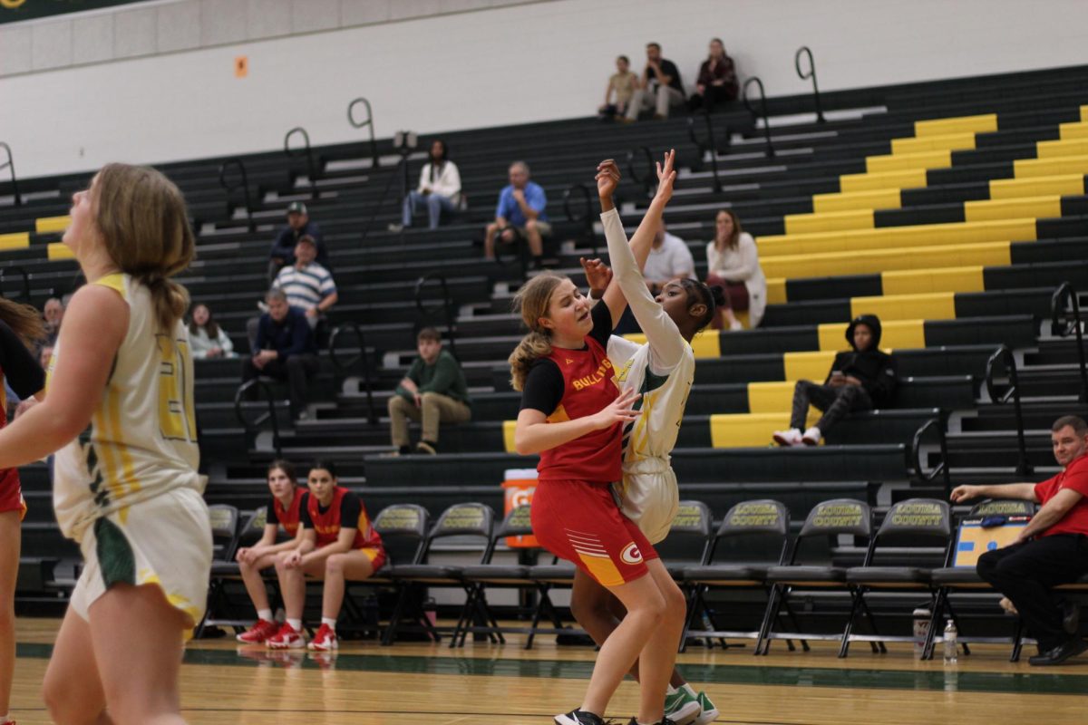 Laila Anthony, Number 4, shoots the ball in the face of a defender. 