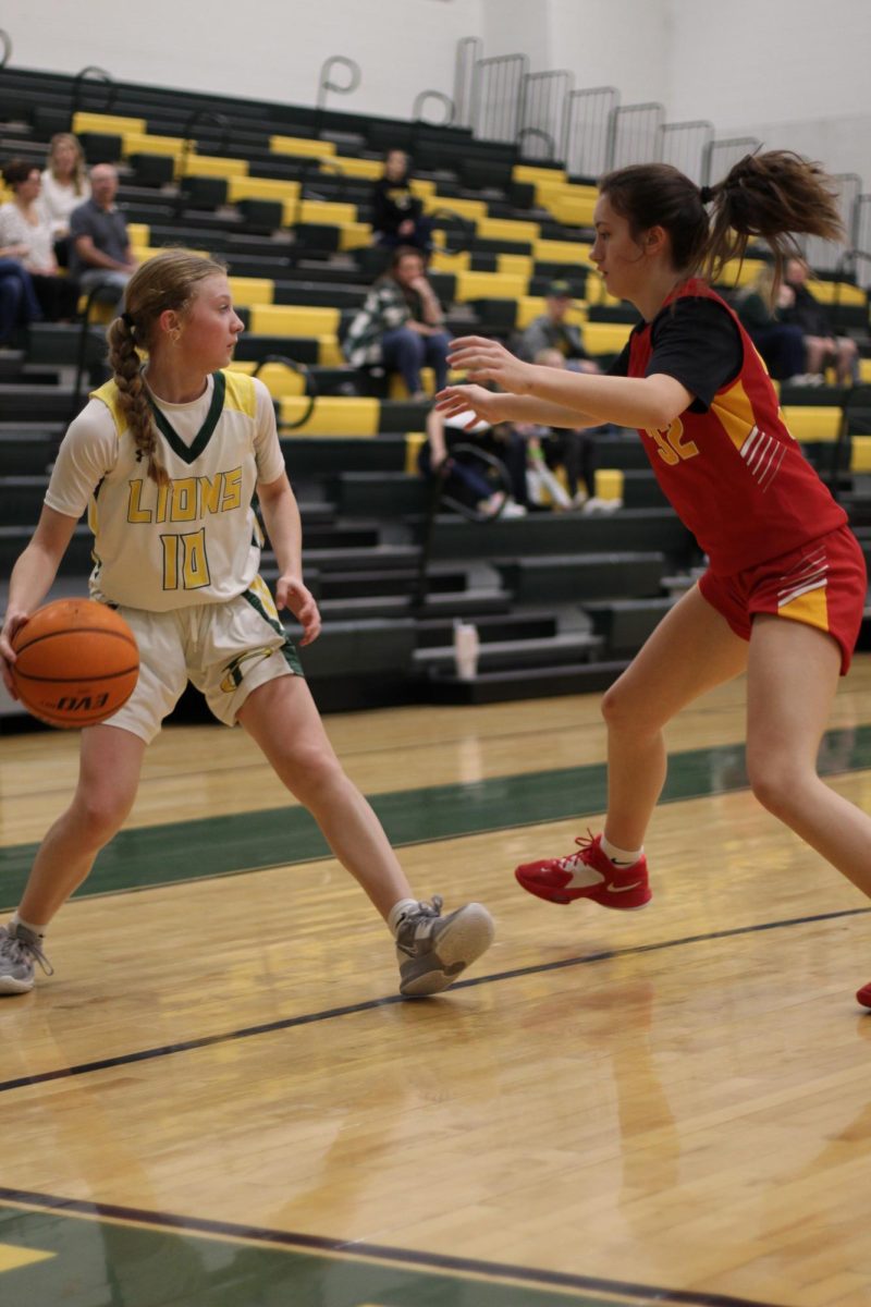 Katelyn Cheely, Number 10, takes a step to pass the ball away from the defender. 