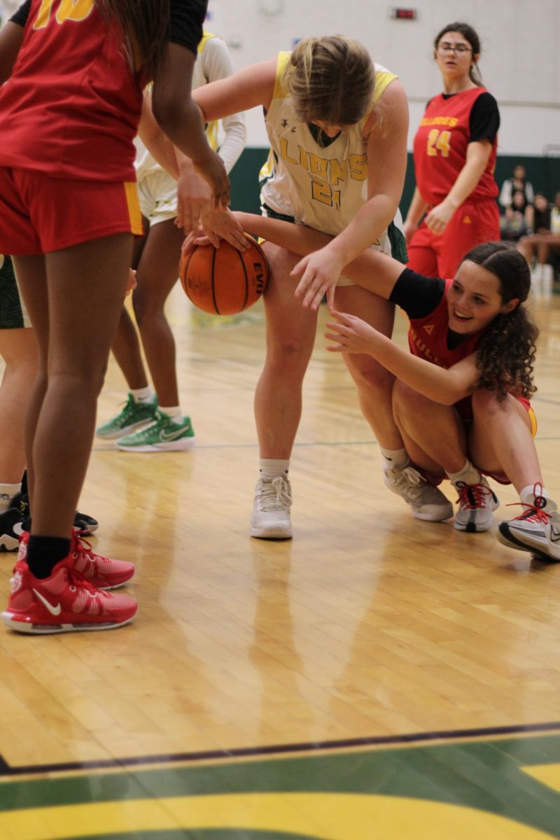 8th grader, Avery Harpster, fights through defenders to secure the ball.