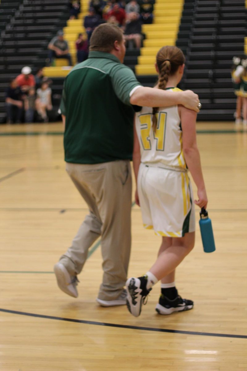 Coach Shreck walks with freshman Point Guard, Hailey Chiles, during half time.