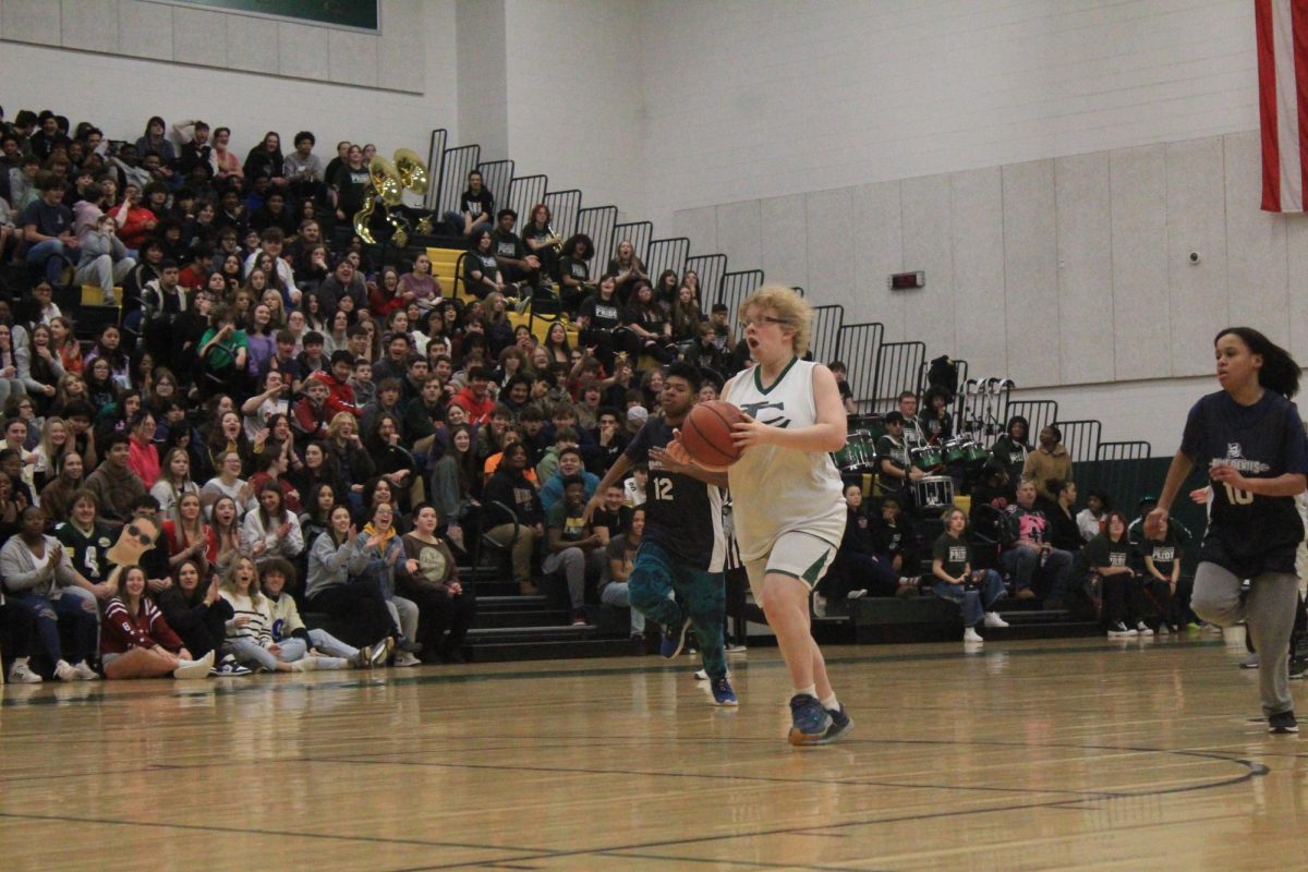 Marley Edwards going up for a fast break with defense trailing behind, and the crowd hyping her up. 