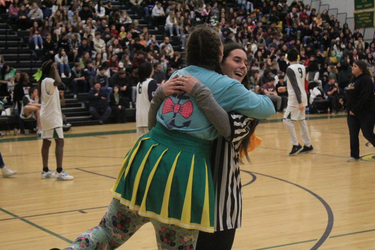 Taylor Yeatts and Shelby Dumin hugging during the medford game.