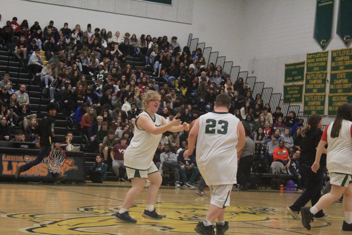 Marley Edwards passing the ball down the court to teammate Dustin Talley. 