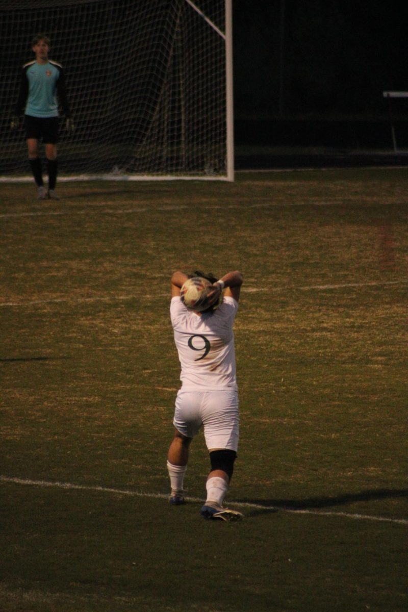 #9 Larson Moreno throwing in the ball to assist an attempt on the goal.