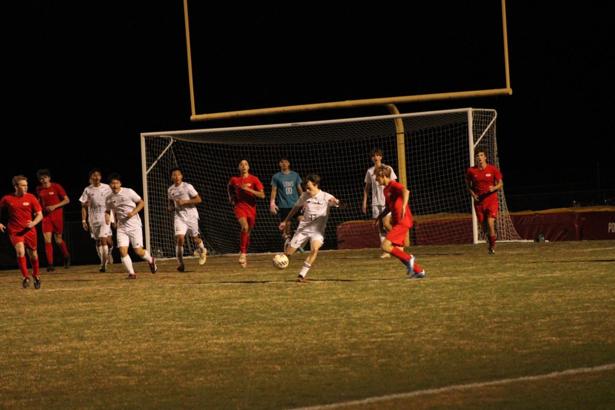Louisa Players defend their goal and clear the ball away to prevent the other team from scoring.