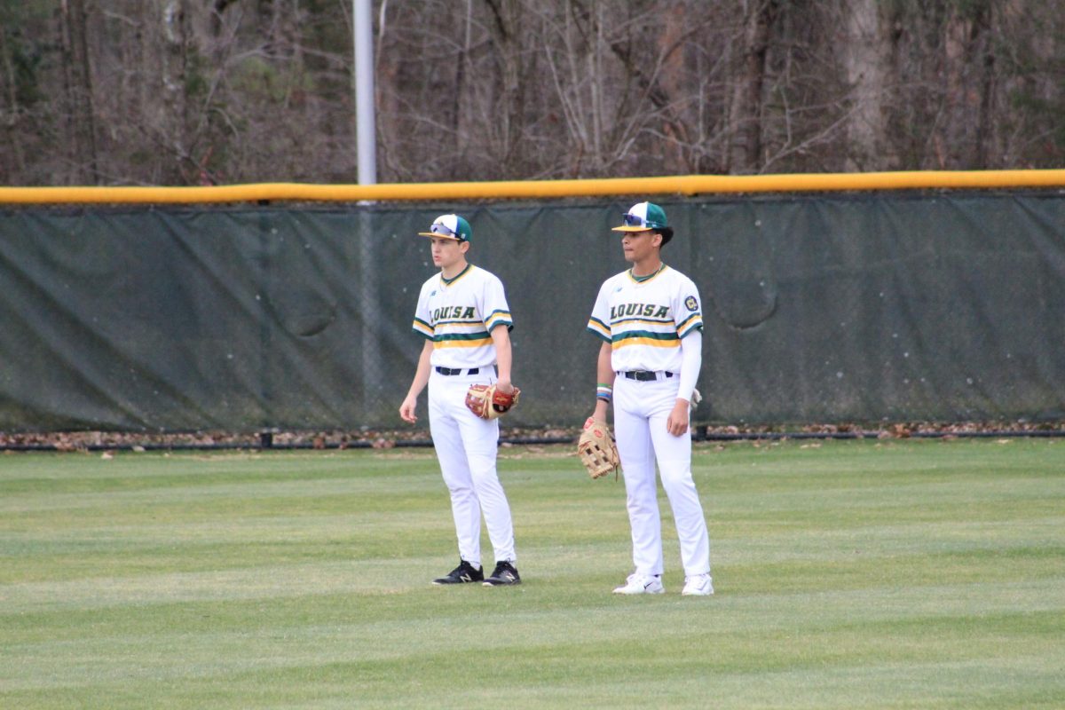 Senior and sophomore duo Austin Grady and Eric Davis in the outfield warming up before the game. 