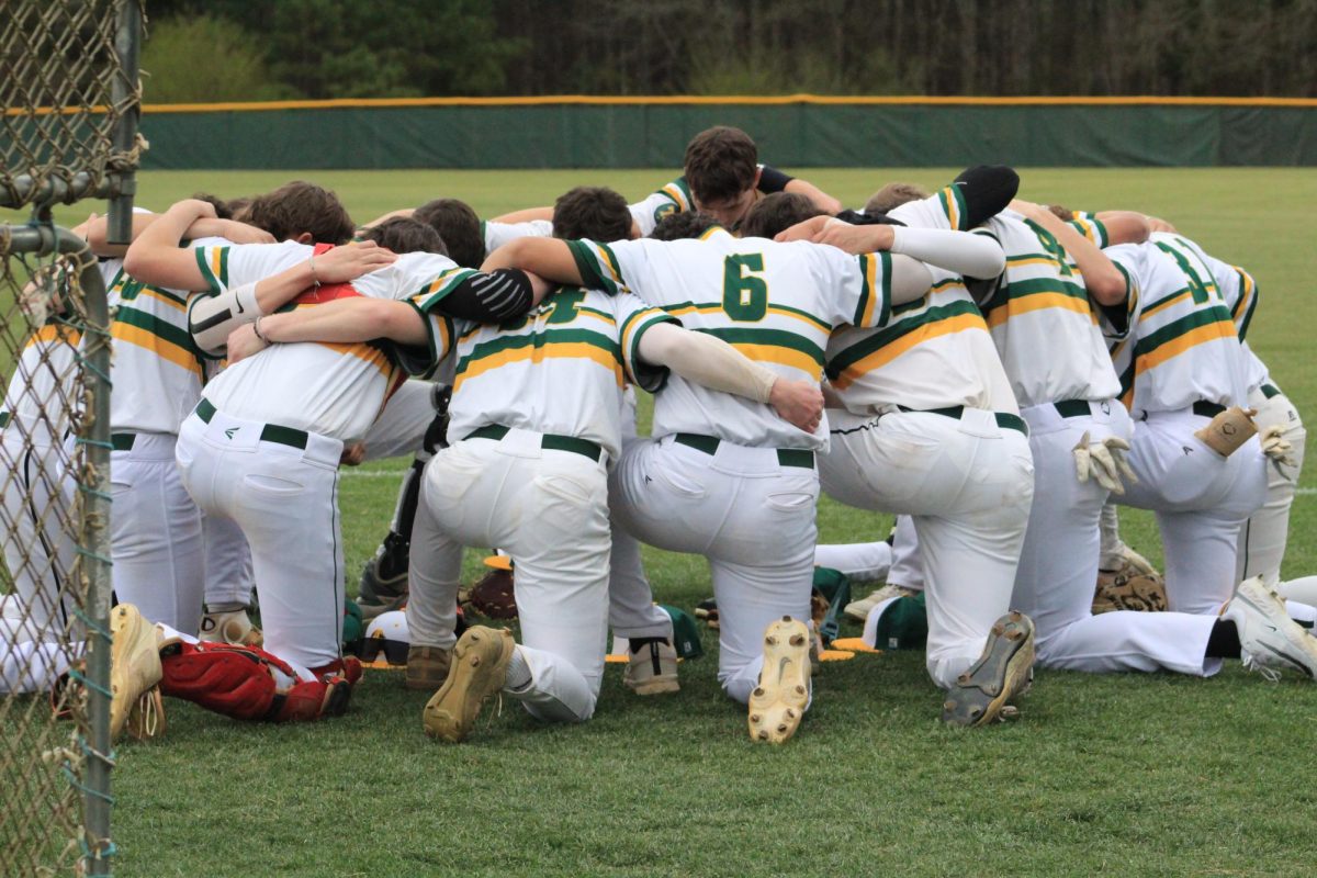 The entire baseball team praying together right before the game. 