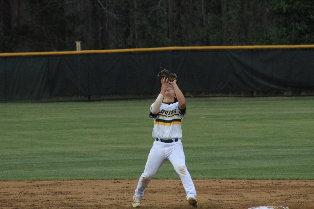 Sophomore Jayden Thompson at second base preparing to catch the ball hit into the air.   